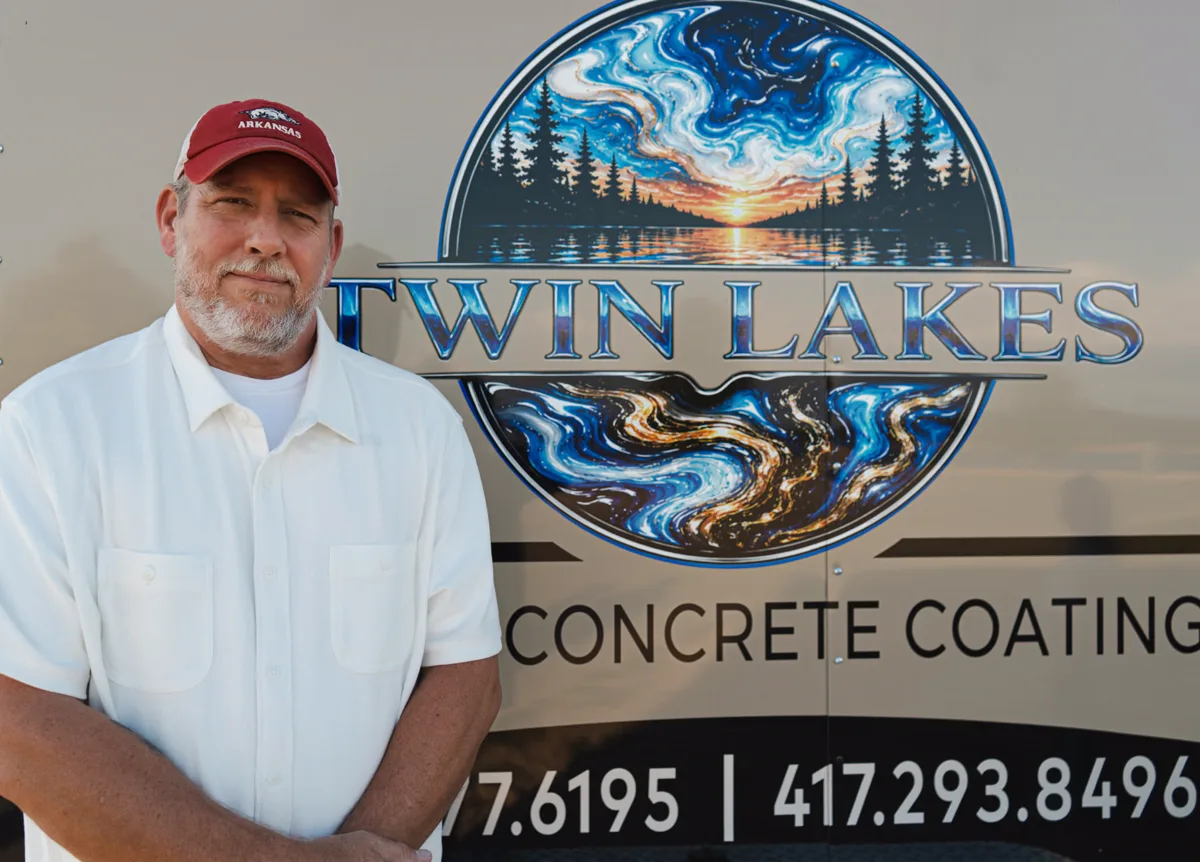 Rex Harrison, co-owner of Twin Lakes Epoxy, standing beside the company trailer wrap