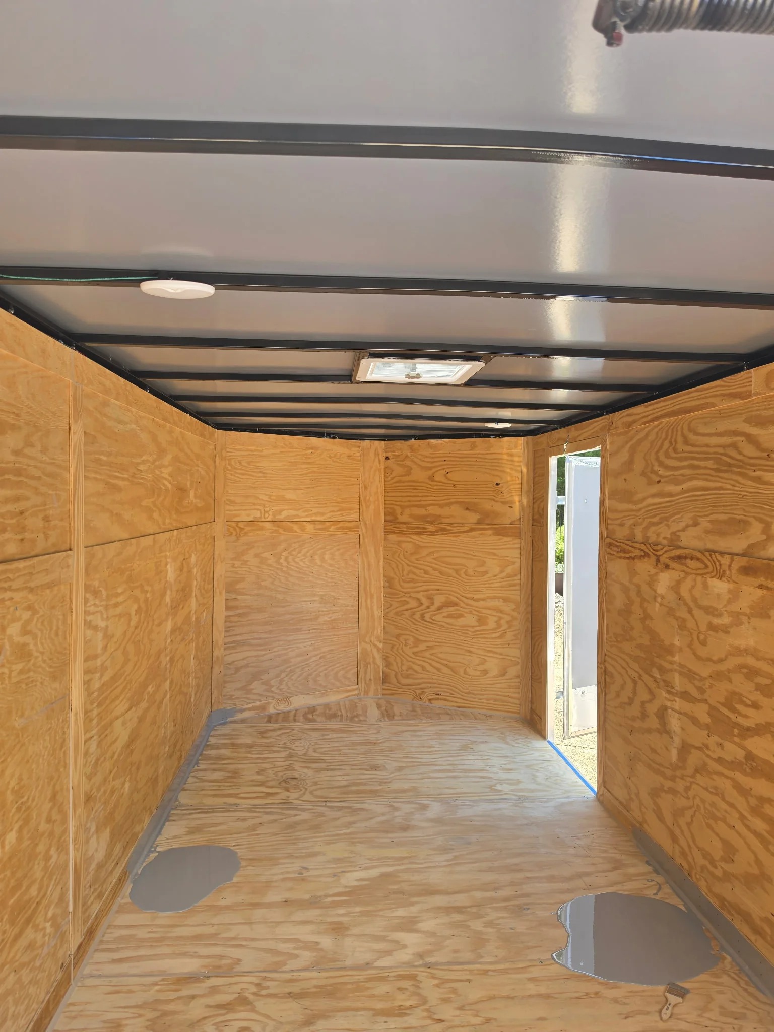 Twin Lakes Epoxy enclosed box trailer with an unfinished plywood floor before the coating was completed