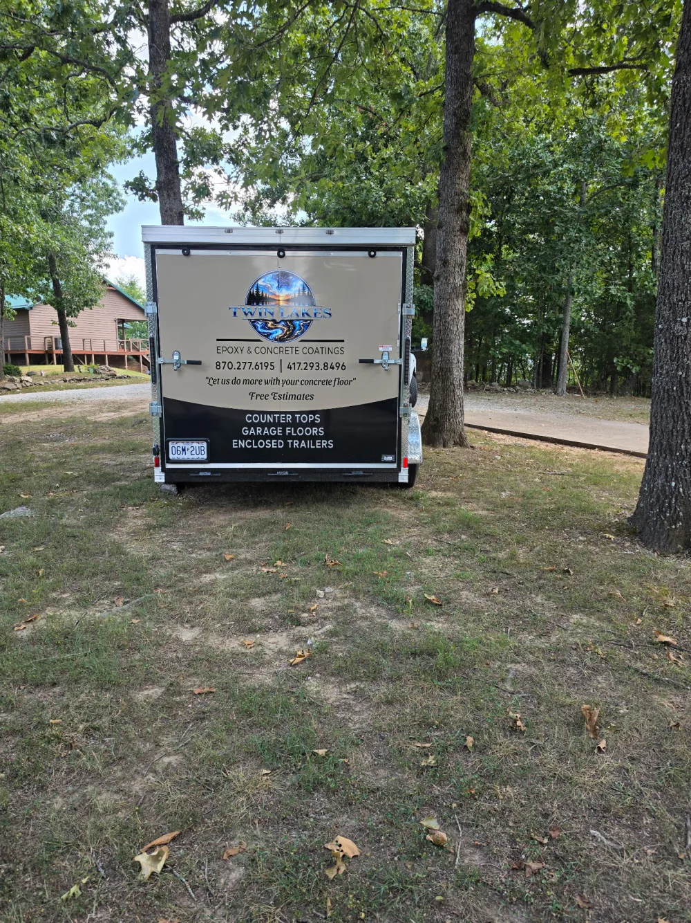 Rear view of the Twin Lakes Epoxy service trailer listing countertops, garage floors, and enclosed trailers