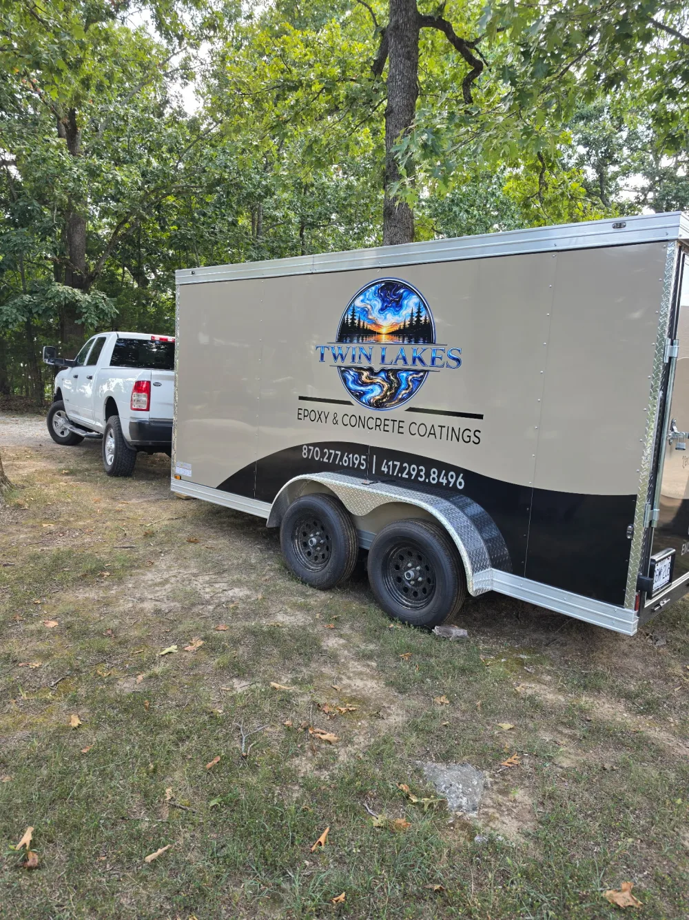 Side view of the Twin Lakes Epoxy and Concrete Coatings branded service trailer