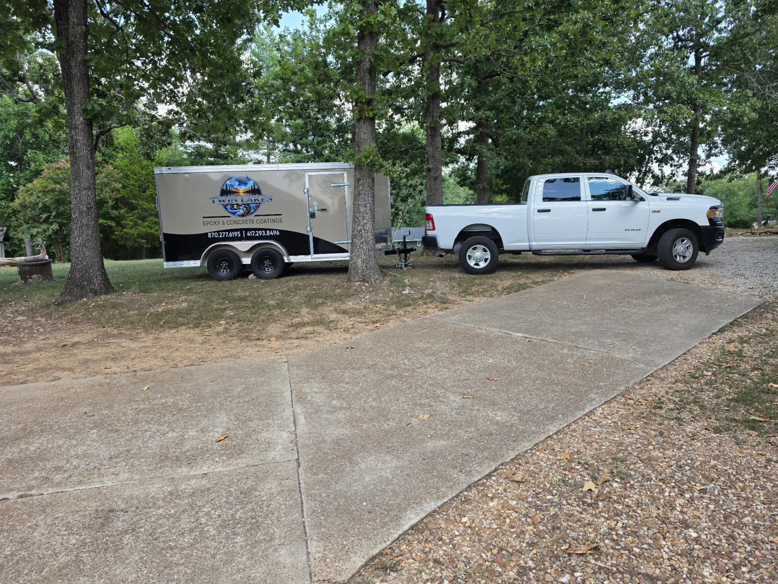 Twin Lakes Epoxy work truck towing the branded epoxy and concrete coatings trailer in the Ozarks